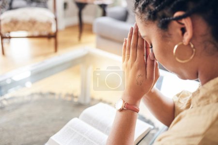 Photo for Worship, bible and woman in living room praying, thank you and praise, mercy and blessing at home. Hands, pray and Christian lady in prayer to God, humble or scripture, guide or forgiveness in house. - Royalty Free Image