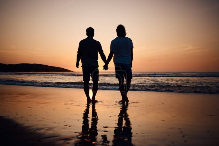 Photo for Silhouette, holding hands and gay men on beach, sunset and shadow on summer vacation together in Thailand. Sunshine, ocean and romance, lgbt couple in nature and fun holiday with pride, sea and sand - Royalty Free Image