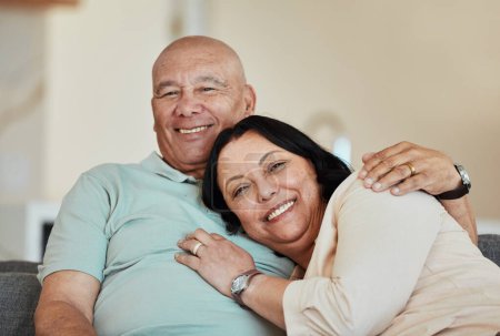 Photo for Portrait, smile and senior couple in home living room, bonding and relax together. Face, happy and elderly man and woman hug on sofa in lounge, enjoying quality time in house with love and retirement. - Royalty Free Image