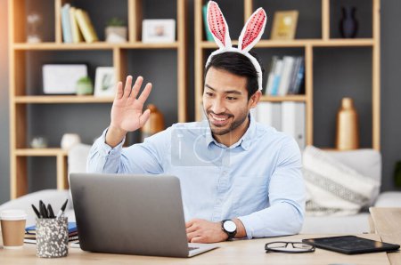Photo for Easter bunny, ears and man on online meeting at home with computer screen and greeting. Remote work, holiday and rabbit costume in virtual call in house for digital education class with male teacher. - Royalty Free Image