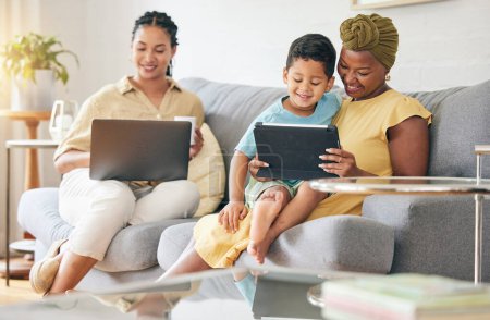 Photo for Laptop, tablet and happy family child, mom or bisexual people reading online info, e learning and remote education. Tech app, lesbian mothers and relax gay woman teaching kid on home living room sofa. - Royalty Free Image
