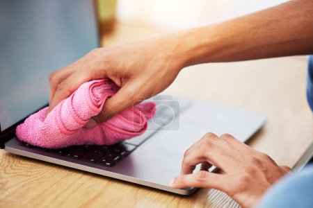Photo for Hands, wipe and laptop with dust, cleaning and hygiene with a cloth, washing or bacteria. Pc, person or worker with fabric, keyboard or covid compliance with technology, antibacterial or disinfection. - Royalty Free Image