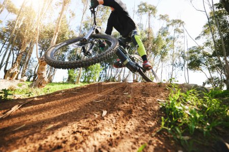 Photo for Bike, jump and dirt with speed in low angle for sports, race and adventure in summer, woods or nature. Extreme cycling, person and outdoor for trail, competition or challenge for fitness in forest. - Royalty Free Image