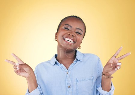 Photo for African woman, peace sign and studio portrait with smile, excited face and trendy clothes by yellow background. Young fashion model, happy or student with hand, icon or emoji with vote for opinion. - Royalty Free Image