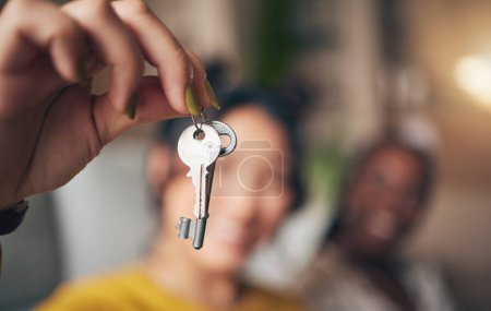 Photo for Keys, hand and new home or people moving in together for real estate investment. Rent, mortgage and loan as homeowner celebrate at apartment, property or house with a partner for freedom or security. - Royalty Free Image