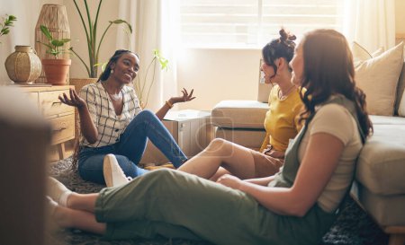 Photo for Happy, gossip and friends on a floor relax, talking and bond with advice in house together. Conversation, drama and women with diversity in a living room speaking, chilling and enjoy weekend freedom. - Royalty Free Image