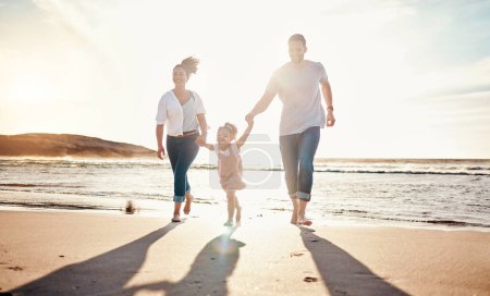 Photo for Family, beach and holding hands, parents and kid with travel and bonding, love and walking together in nature. Vacation, ocean and happy people outdoor, parents and child with sun and adventure. - Royalty Free Image