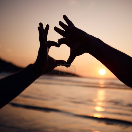 Photo for Beach sunset, nature silhouette and person with heart hands sign for love, freedom and ocean vacation. Adventure, emoji health icon and couple support with natural wellness, tropical care or shape. - Royalty Free Image