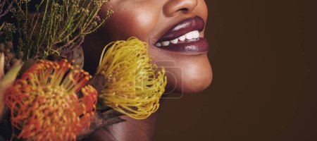 Photo for Beauty, makeup and plants with lips of black woman in studio for natural, spa and mockup space. Cosmetics, flowers and closeup with model on brown background for sustainability, glow and banner. - Royalty Free Image