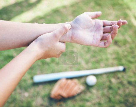 Photo for Above, field and hand pain from baseball, sports and training for a competition with an injury. Fitness, burnout and a person or athlete with a muscle accident or arm strain after a softball match. - Royalty Free Image