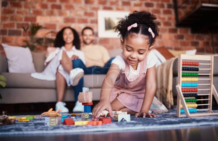 Photo for Child, toys and playing in home with development and building block in living room. Family, fun and youth learning with a young girl and parents in a house together with care and bonding education. - Royalty Free Image