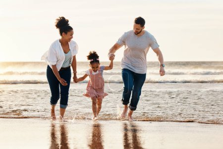 Photo for Family, running and ocean, beach and sunset, happiness and fun together with games and bonding on vacation. Travel, adventure and playful, parents and child, happy people in nature and holding hands. - Royalty Free Image