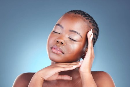 Photo for Beauty, black woman and calm with skincare, cosmetics and facial wellness in a studio. Blue background, makeup and dermatology with skin glow and shine from treatment with manicure and sleeping. - Royalty Free Image