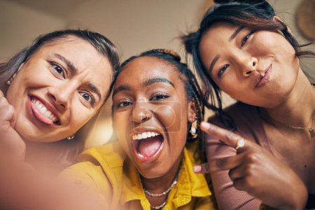 Photo for Friends, selfie and women happy, crazy and bond in a living room at home together on the weekend. Portrait, emoji and people with diversity pose for profile picture, blog or social media memory post. - Royalty Free Image