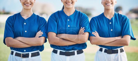 Photo for Softball, arms crossed and women team proud or ready for outdoor sports match, game and competition together. Smile, teamwork and players in solidarity for fitness training and workout on a field. - Royalty Free Image
