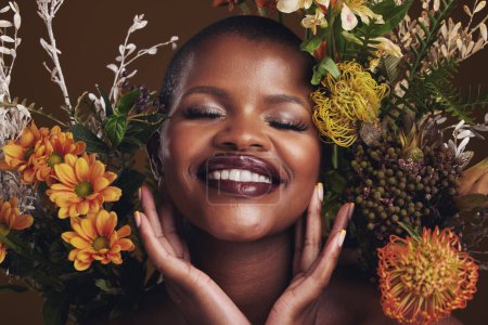 Photo for Skincare, cosmetics and protea with the face of a black woman in studio on brown background for natural treatment. Smile, plant or beauty and a happy model for eco or aesthetic wellness with flowers. - Royalty Free Image