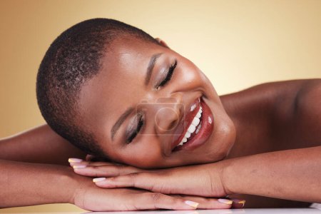 Photo for Makeup, face and beauty of happy woman in studio for self care, skin glow or cosmetics. Closeup of African aesthetic model person with facial shine, dermatology or relax on hands on beige background. - Royalty Free Image