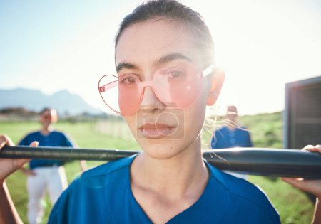 Photo for Baseball player, sunglasses and a sports person with bat outdoor on pitch for performance at competition. Face of athlete or softball woman for portrait, commitment or fitness for game or training. - Royalty Free Image