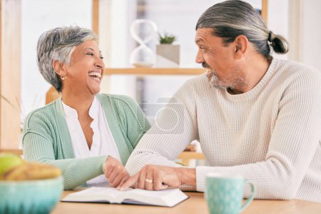 Photo for Reading, book and senior couple at home with bible study and religion together in marriage. Laughing, happy and elderly people with worship, learning and christian conversation with love and care. - Royalty Free Image