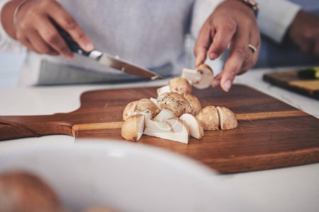 Photo for Cut, mushroom and person hands cooking vegetable in a kitchen on a board or table in a home as healthy a chef. Salad, food and woman prepare produce for a supper, lunch or dinner for diet meal. - Royalty Free Image