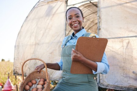 Photo for Portrait, farm and black woman with clipboard and chicken eggs for sustainability, agriculture and supply chain in countryside. Face, smile and farmer with checklist or poultry, produce or management. - Royalty Free Image