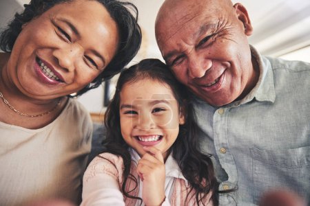 Photo for Portrait, selfie or happy grandparents with girl child in living room bonding together as a family in Mexico. Profile picture, faces or grandmother with grandfather or kid at home on holiday vacation. - Royalty Free Image