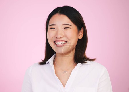 Photo for Portrait, happy and asian woman laugh in studio with funny, joke or silly humor on pink background. Comic, smile and face of female model laughing to goofy, comedy or playful, good mood or positivity. - Royalty Free Image
