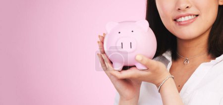 Photo for Woman, piggy bank and mockup space in savings, investment or financial growth against a pink studio background. Female person, banner and hands holding piggybank in finance or profit on mock up. - Royalty Free Image