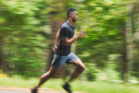 Photo for Sports man, action and running in park with speed, cardio workout or power of motion blur. Runner, athlete or training for marathon race with energy, dynamic exercise or fast performance pace outdoor. - Royalty Free Image