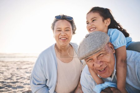 Photo for Fun, beach and girl playing with her grandparents on a family vacation, adventure or holiday. Happy, smile and child on a piggyback ride and bonding with her grandmother and grandfather by the ocean - Royalty Free Image