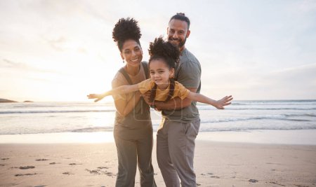 Photo for Family, portrait and beach for airplane, travel and freedom, bond and fun in nature together. Love, flying and happy girl child with parents at the ocean playing, relax and smile on summer holiday. - Royalty Free Image