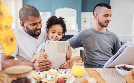 Photo for Gay family, tablet and child with breakfast at home for e learning, bonding and education on internet. Adoption, lgbt men or parents with a happy kid and technology in morning with food on a table. - Royalty Free Image