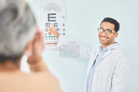 Photo for Vision, test for eyes and reading chart, optometrist and patient, healthcare and alphabet at clinic. Eye care, glasses and diagnosis with assessment, health and wellness, people with trust and help. - Royalty Free Image