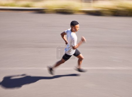 Photo for Health, running and motion blur with a sports man on a road for his cardio or endurance workout from above. Exercise, fitness and a runner training for a marathon in the mountains during summer. - Royalty Free Image