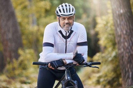 Photo for Fitness, portrait and senior man with bicycle in a forest for cycling, sports or training for off road hobby in nature. Face, smile and happy cyclist with mountain bike in a park for biking adventure. - Royalty Free Image
