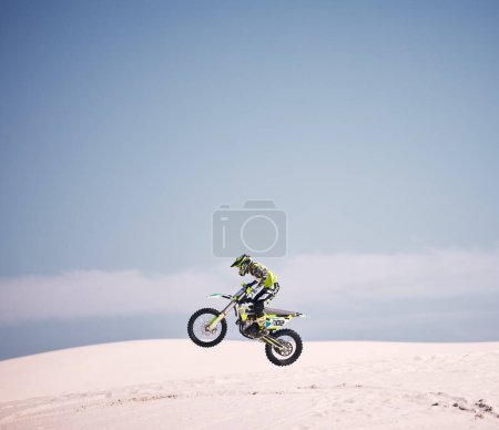 Photo for Bike, sky and jump with a man on mockup riding a vehicle in the desert for adventure or adrenaline. Motorcycle, speed and space with an athlete on sand in nature for freedom, power or competition. - Royalty Free Image