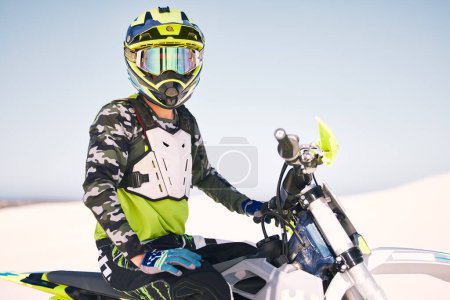 Photo for Sports, desert and man with helmet on motorbike for training, workout and challenge on sand. Extreme transport, travel and cyclist with motorcycle for adventure, freedom and adrenaline for action. - Royalty Free Image