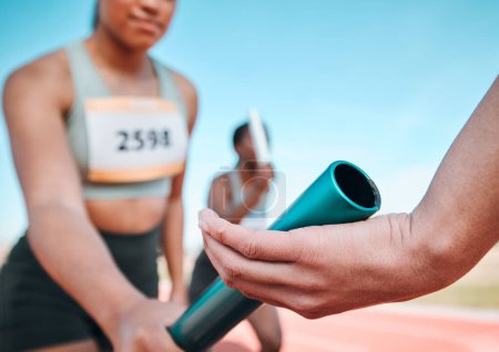 Woman, team and hands with baton in relay, running marathon or sports fitness on stadium track. Closeup of people holding bar in competitive race, sprint or coordination for teamwork or performance.