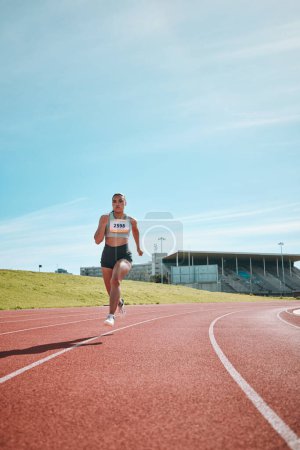 Photo for Woman, athlete and running on stadium track in fitness, workout or cardio exercise for practice or training. Female person or runner in sports competition, performance or outdoor motivation on mockup. - Royalty Free Image
