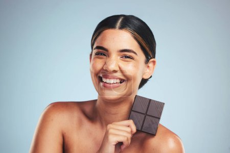 Photo for Portrait, chocolate and happy woman in studio with diet, craving or unhealthy luxury snack on grey background. Face, smile and lady model with candy bar, sugar and cocoa, addiction or diet temptation. - Royalty Free Image