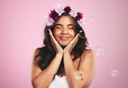 Photo for Beauty, relax and bubbles with woman and flower crown in studio for cosmetics, skincare and wellness. Hair care, spa treatment and face with person on pink background for spring, glow and makeup. - Royalty Free Image
