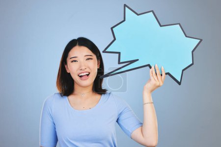 Photo for Speech bubble, woman voice and student presentation, chat or communication for college opportunity or forum. Portrait of asian person with opinion, feedback or mockup poster on blue studio background. - Royalty Free Image