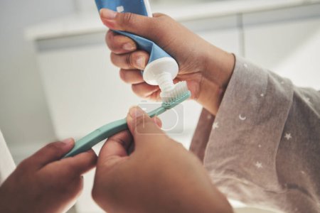 Photo for Hands, brushing teeth and a parent teaching a child about dental care with a family in a bathroom together closeup. Toothbrush, toothpaste and dentist product with people in a home for oral hygiene. - Royalty Free Image
