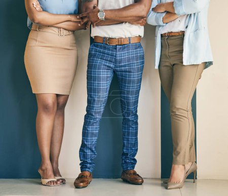 Photo for Business people, legs and arms crossed at wall, human resources and recruitment employees. Hr, feet of man and women standing in office with confidence in teamwork, opportunity and professional group. - Royalty Free Image