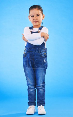 Photo for Frustrated, child and arms crossed with tantrum in studio with mockup space. Kid, young girl and angry with cross frown and rejection with youth and mad attitude with blue background and grumpy. - Royalty Free Image