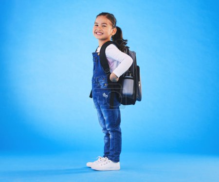 Photo for School, backpack and portrait of child on blue background ready for class, learning and education. Student, happy and young girl with bag excited for lesson, academy and kindergarten in studio. - Royalty Free Image