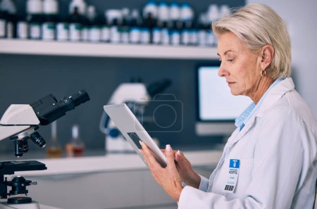 Photo for Science, tablet and research with woman in laboratory for planning, medical and pharmacy. Medicine, healthcare and digital report with mature scientist reading online for email, data and result. - Royalty Free Image
