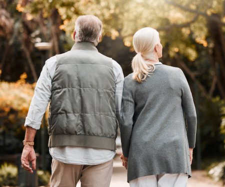 Photo for Holding hands, love and back with old couple in nature for bonding, happy and support. Relax, happiness and retirement with senior man and woman walking in countryside for vacation and commitment. - Royalty Free Image