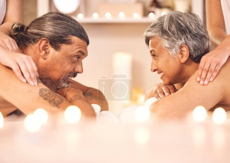 Photo for Mature couple, romantic massage at spa in candle light and wellness, relax and smile together. Holistic health therapy, zen and calm man with woman in profile on table in luxury salon in retirement - Royalty Free Image