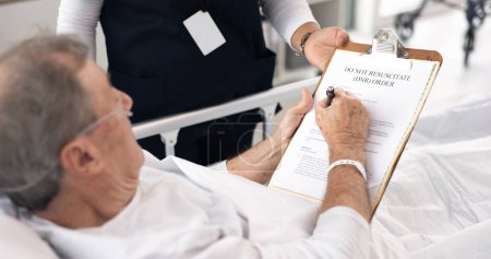 Photo for Hospital, doctor and man sign dnr form on clipboard for medical service, will and do not resuscitate. Healthcare, cancer and health worker with application for senior patient for insurance in clinic. - Royalty Free Image